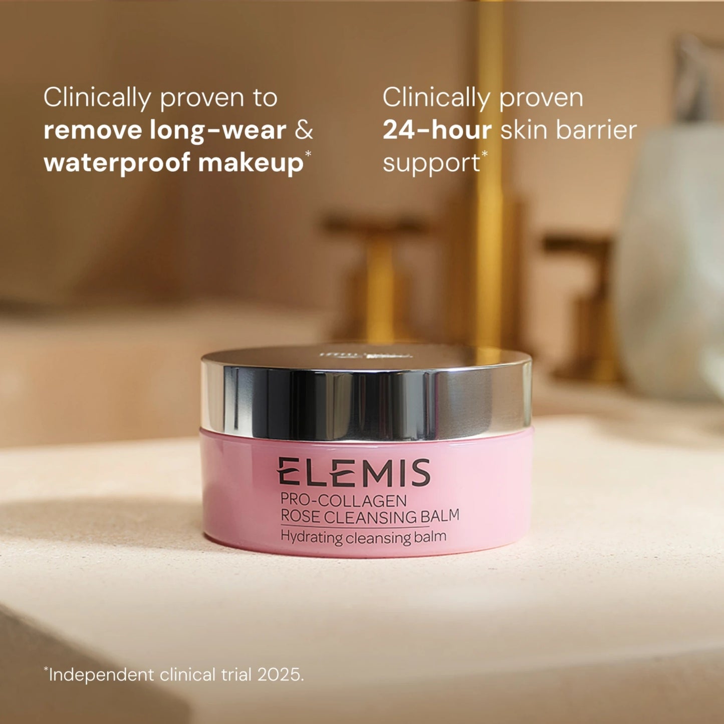 Elemis Pro-Collagen Rose Cleansing Balm in a light pink jar with a reflective silver lid, set on a beige countertop with a softly blurred bathroom background. White text overlays highlight its clinical makeup removal and skin barrier support benefits.