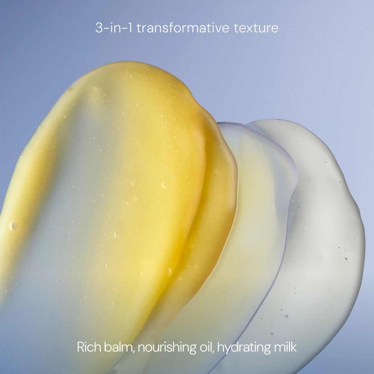 Three smooth, translucent product textures layered diagonally on a soft blue gradient background, with text reading '3-in-1 transformative texture' at the top and 'Rich balm, nourishing oil, hydrating milk' at the bottom.