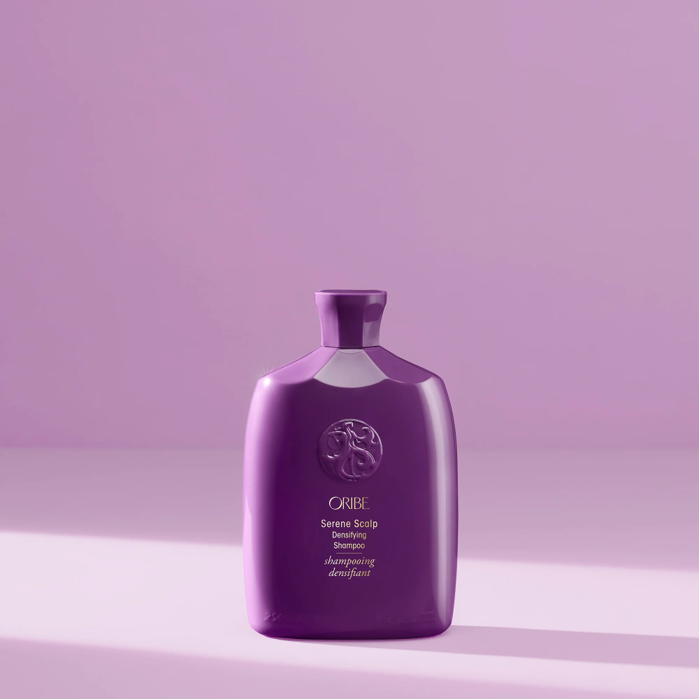 Bottle of Oribe Serene Scalp Densifying Shampoo for scalp care and hair volume.