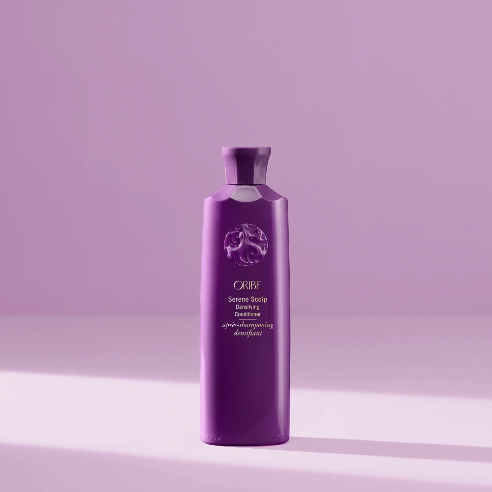 Bottle of Oribe Serene Scalp Densifying Conditioner for scalp care and hair thickening.